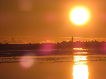 Scenic view of sea against orange sky