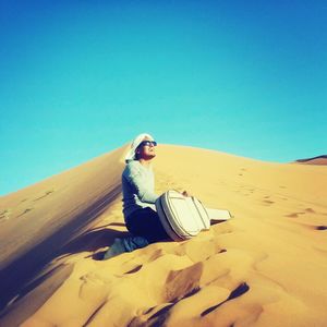 View of desert against clear blue sky