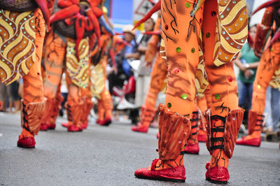 Low section of people dancing on street during tugob festival