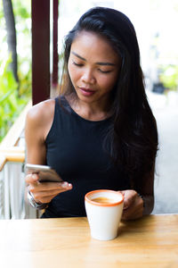 Woman sitting on table at cafe