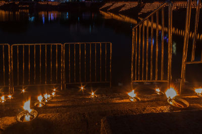 Illuminated candles on fire at night