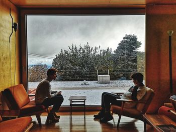 People relaxing on table against sky