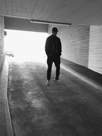 Full length rear view of man walking in subway