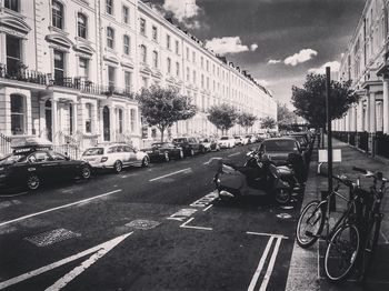 Vehicles on road against buildings in city