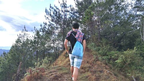 Full length of woman standing in forest