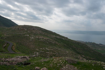 Scenic view of sea and mountains against sky