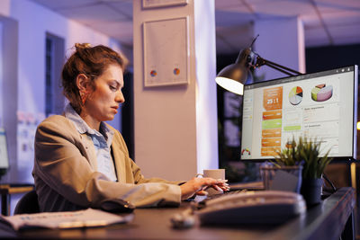 Young woman using laptop on table