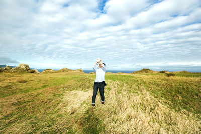 Full length of man standing on field against sky