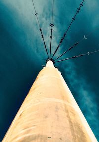 Low angle view of tall building against blue sky