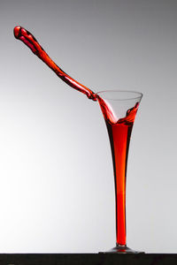 Close-up of red chili over white background