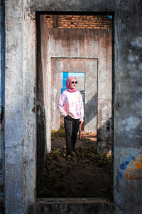 Full length of boy standing against door