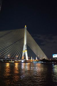 Low angle view of suspension bridge at night