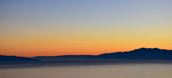Scenic view of sea against romantic sky at sunset