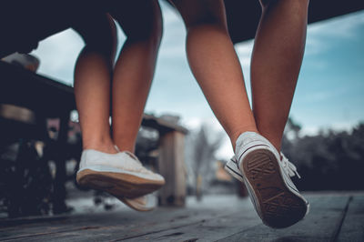 Low section of woman wearing high heels