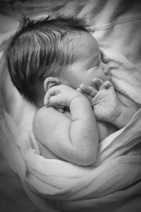 High angle view of baby girl sleeping on bed at home