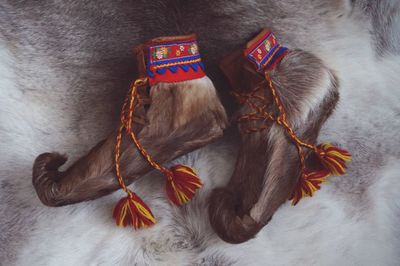 Directly above shot of traditional fur shoes on rug