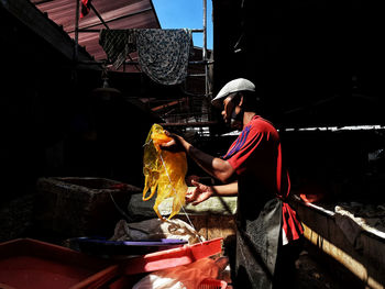 Man working at market stall