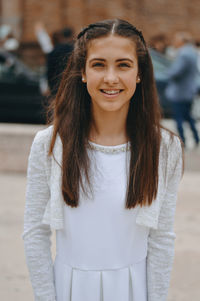 Portrait of smiling young woman standing outdoors