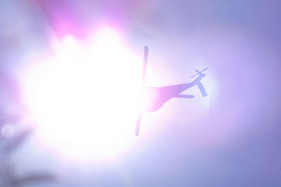 Low angle view of airplane flying against sky