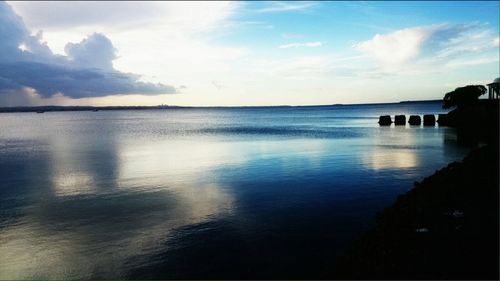 Scenic view of sea against cloudy sky