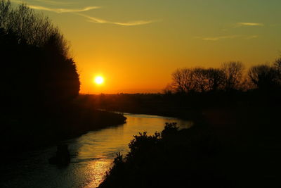 Scenic view of lake against orange sky