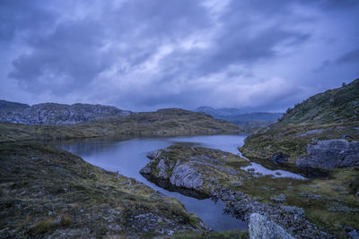 Scenic view of lake and mountains against sky