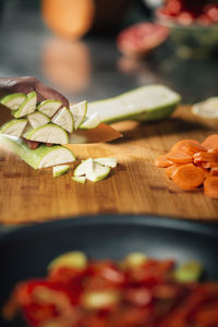 Cutting fresh zucchini - preparing vegan meal