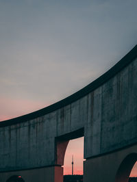 Low angle view of bridge against sky during sunset