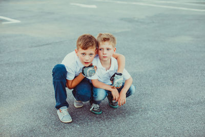 Portrait of friends sitting on shore