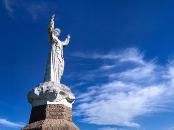 Low angle view of statue against cloudy sky