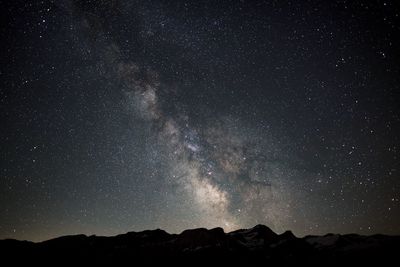 Scenic view of mountains against star field