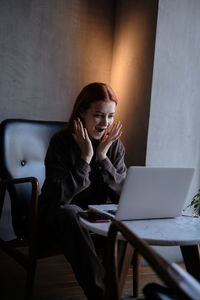 Surprised woman looking at laptop