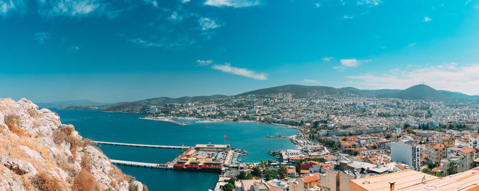 High angle view of townscape by sea against sky