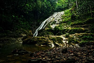 Scenic view of waterfall against sky at night