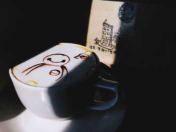 Close-up of coffee cup over black background