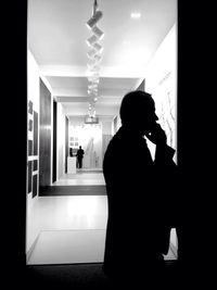 People walking in illuminated corridor