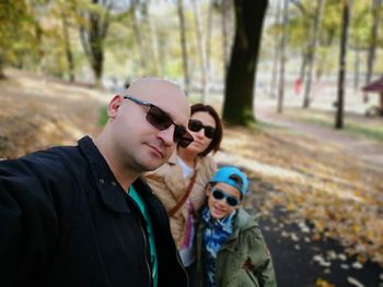 Portrait of family wearing sunglasses in park