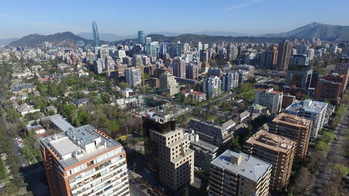 High angle view of modern buildings in city against sky