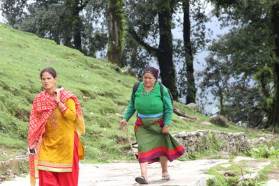 Full length of a woman walking on dirt road