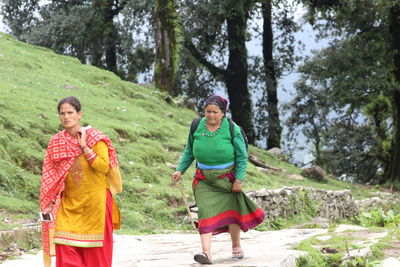 Full length of a woman walking on dirt road