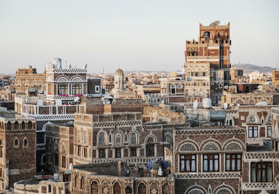 Old buildings in city against sky