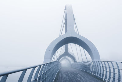 Low angle view of walking and bicycle bridge. misty. 
