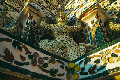 Low angle view of thai statue in wat arun temple