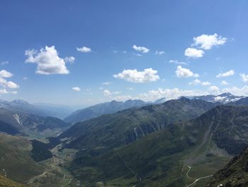 Scenic view of mountains against cloudy sky