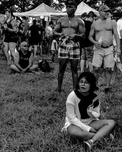 Portrait of friends sitting on field