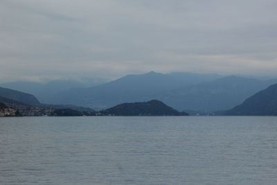 Scenic view of sea and mountains against sky