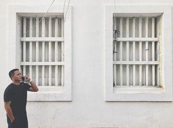 Man photographing through window