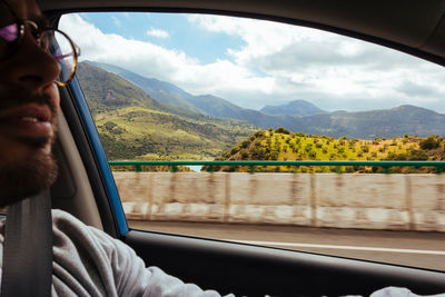 Man seen through car window