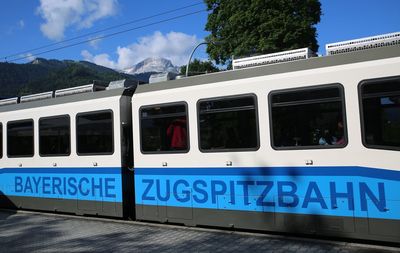 Train on railroad track against blue sky