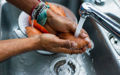 Man washing sweet potato